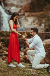 man proposing on bended knee