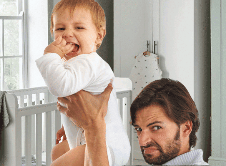 Daddy holding up a baby that has a dirty diaper