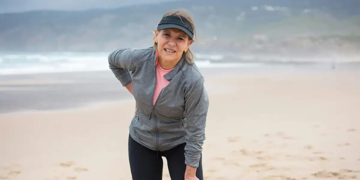 Woman holding sore knee